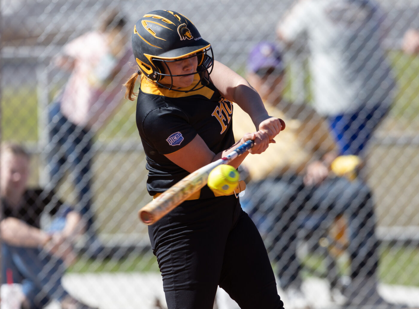 Softball player Chelsey Wilkes hits the ball