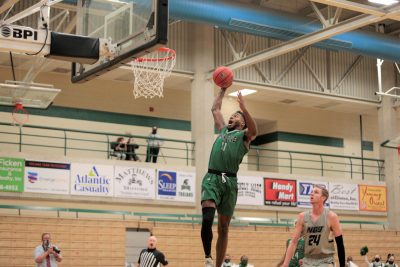 Johnny Hughes dunks the basketball during a Mount Olive basketball game