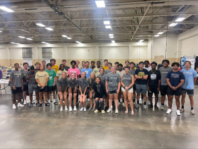 A posed group photo of FTCC athletes inside the Crown Complex.