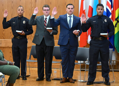 Four individuals taking an oath for BLET graduation June 2024