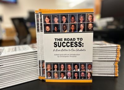 Stacks of copies of "The Road to Success" book