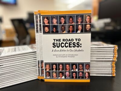 Stacks of copies of "The Road to Success" book