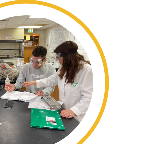 Two students conducting a chemistry experiment.